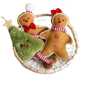 Three-piece Christmas plush set with gingerbread men and tree in a wicker basket