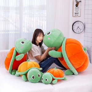 Detail of cute turtle pumpkin plush cushions in various sizes for office and home decor