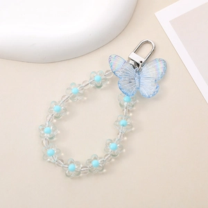 Detail of blue butterfly pendant and flower beads on a silver lobster clasp keychain