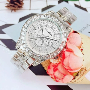 Close-up of silver steel watch featuring sparkling cubic zirconia crystals on bezel