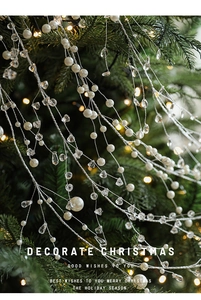 Close-up of elegant Christmas pearl and crystal bead garland hanging on a festive tree