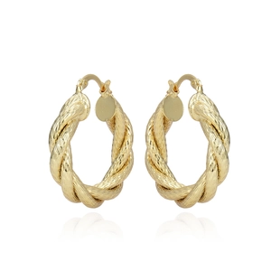 Vintage hollow gold-plated twist hoop earrings with spiral texture on white background