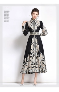 Macro detail of paisley print on long-sleeved A-line dress with belted waistline