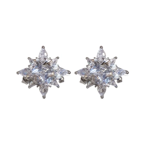 Elegant silver star flower ear cuff earrings with sparkling zircon stones on white background
