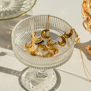 18k gold plated moon pendant jewelry set with crystals and pearls in water backdrop