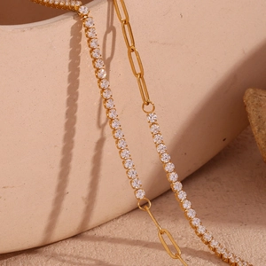 Macro shot of 18K gold-plated tennis chain with white zircons and paperclip link design