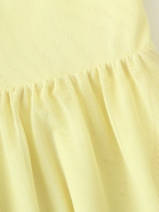 Detailed close-up of pleated light yellow textured fabric with fine stitching details
