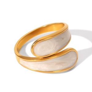 Detail of adjustable gold bypass ring with elegant white enamel inlay and pearly finish