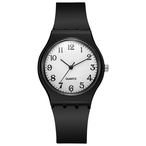 Close-up of minimalist black silicone watch with clear Arabic numerals and white dial