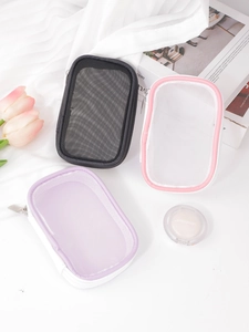 Three minimalist mesh travel pouches in black and pastel colors with metal zippers