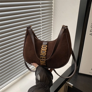 Vintage dark brown suede crescent shoulder bag with golden hardware and adjustable strap
