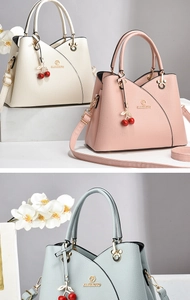 Detailed view of fashionable handbags in cream, pink, and blue with cherry charms