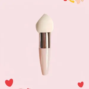 Detailed view of makeup sponge with teardrop head and ergonomic light pink handle
