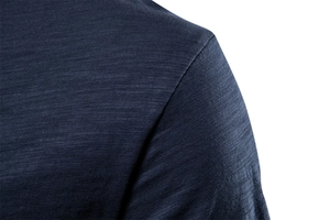 Macro shot of navy blue slub cotton texture and shoulder stitching detail on V-neck T-shirt