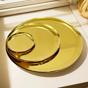 Set of three golden Nordic style round stainless steel storage trays in various sizes