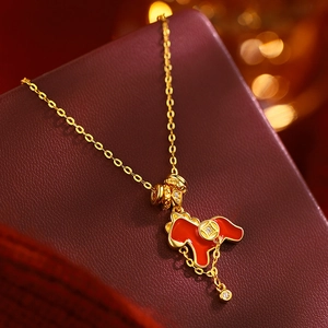 Macro detail of gold-plated horse pendant with red enamel and dangling crystal charms