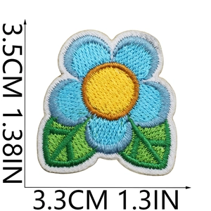 Close-up of blue flower embroidered patch with size markings 3.5cm by 3.3cm on white backdrop
