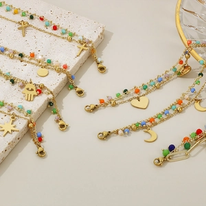 Golden multi-layer charm bracelets with colorful beads and celestial heart pendants