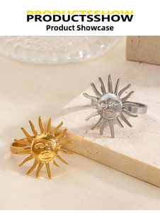 Detail shot of sun-shaped decorative rings in gold and silver finish on stone