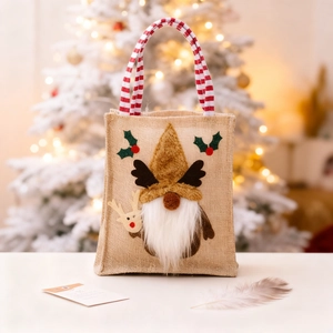 Linen Christmas gift bag with elf reindeer design and striped handle for holiday season