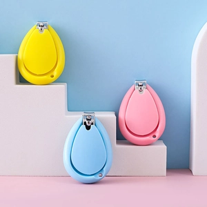 Three colorful teardrop baby nail clippers in yellow blue and pink on white steps