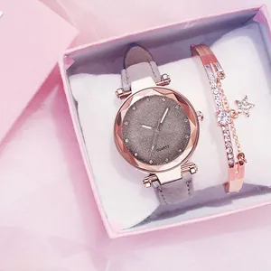 Close-up of women's rhinestone watch with frosted strap and star bracelet in gift box