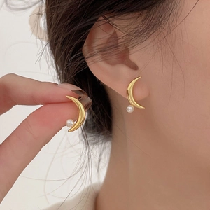 Elegant gold crescent moon stud earrings with white pearl accents for a stylish look