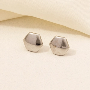 Detail view of silver 304 stainless steel hexagonal earrings with hammered texture