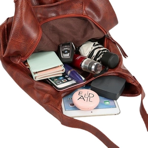 Brown lychee leather tote bag showing large capacity for tablet and daily items