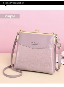 Detail of purple faux leather bag showing crocodile texture and retro metal clasp