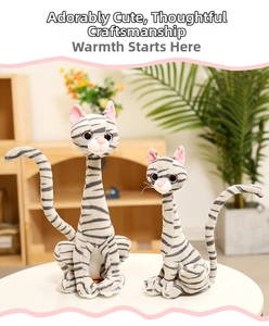 Detailed view of grey striped plush cat dolls in two sizes on a white table in home setting