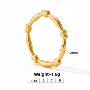 Detail showing 2mm gold heart ring width and 1.6g weight on white background