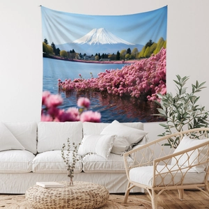 Detailed Mount Fuji tapestry with pink flowers hanging over a sofa in a bright living room