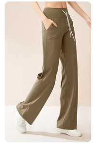 Close-up of olive green wide-leg yoga pants with high waist and white drawstring
