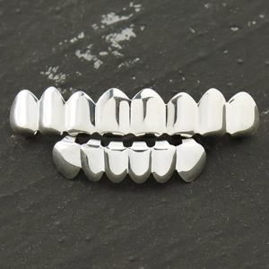 Macro shot of silver polished hip hop grillz set featuring 8 top and 6 bottom teeth teeth