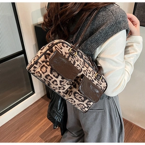 Detail of vintage leopard print shoulder bag with brown leather handles and side pockets