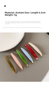 Detail shot of 6.5cm acetate hair clips in candy colors on grey leather background