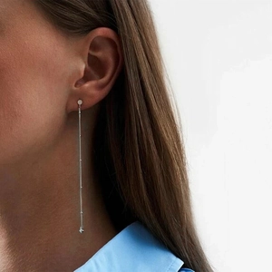 Minimalist S925 sterling silver long chain tassel drop earrings worn by a model