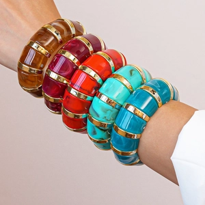Detailed view of bohemian acrylic bangles with marble textures and gold metal dividers
