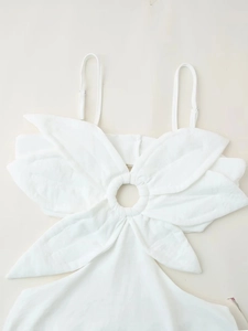 Détail du haut papillon blanc avec anneau métallique et texture de tissu plissé