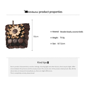 Detailed view of handmade woven crossbody bag with coconut shell beads and wooden flower