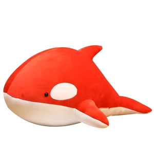Red orca plush toy with soft streamline body and white belly shown on white background