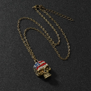 Antique bronze skull pendant necklace with US flag rhinestones on black background