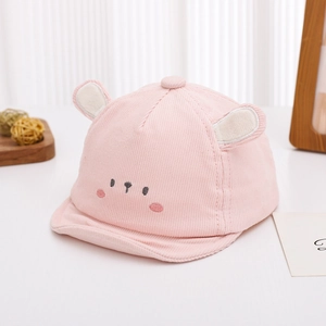 Detail of pink corduroy baby hat featuring cute plush ears and embroidered bear face