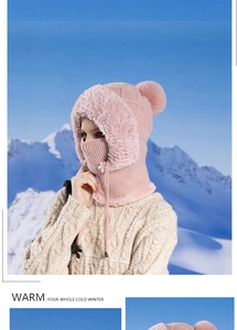 Pink winter knit hooded scarf with faux fur trim shown against a snowy mountain backdrop