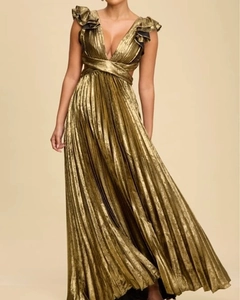 Macro shot of metallic gold pleated fabric and delicate ruffle details on a long dress