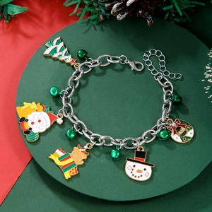 Detail view of a Christmas charm bracelet with colorful Santa, reindeer and tree pendants