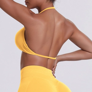 Macro detail of the bright yellow seamless ribbed fabric and open back sports bra design