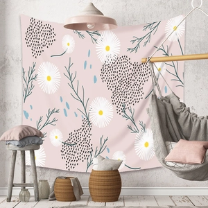 Cozy home setting with pink daisy tapestry hung above a stylish wooden hanging chair