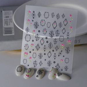 Detail view of vintage French black frame nail stickers with floral embossed effect